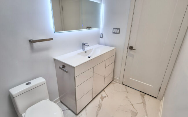Bathroom vanity and mirror installed during a renovation in a Toronto home